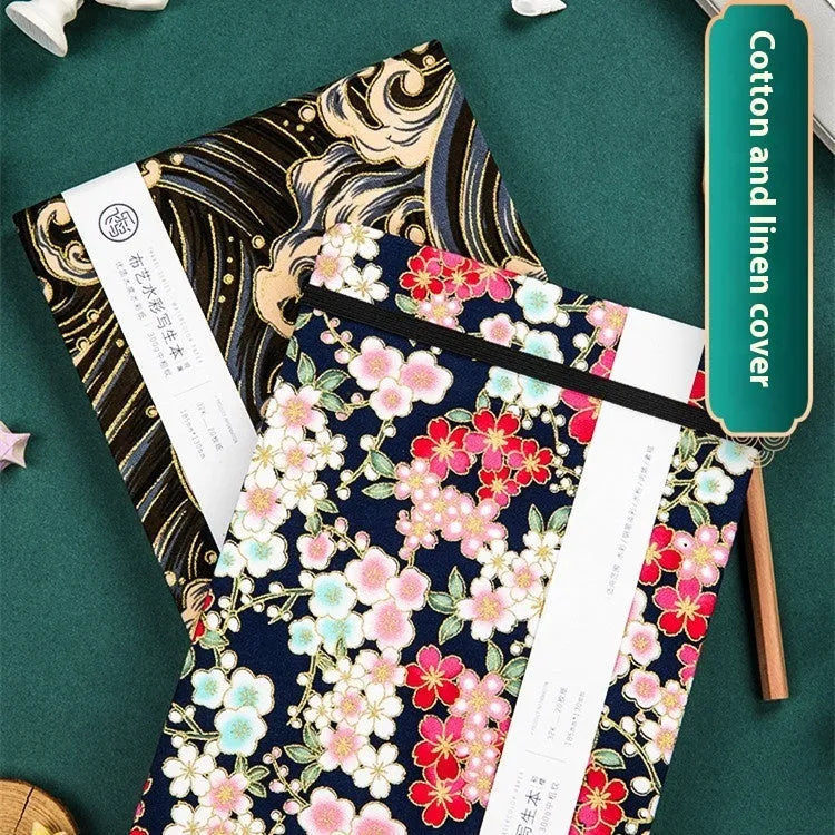 Fabric-bound handmade watercolour notebook with artistic cover design for character sketching
