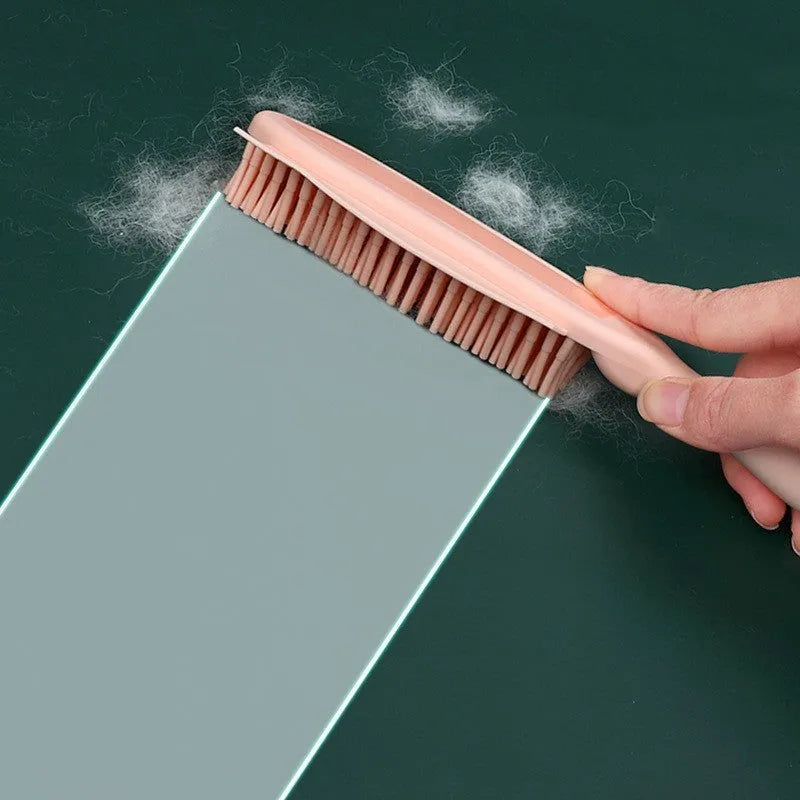 Green and pink dog brush with rubber bristles and pet hair remover function