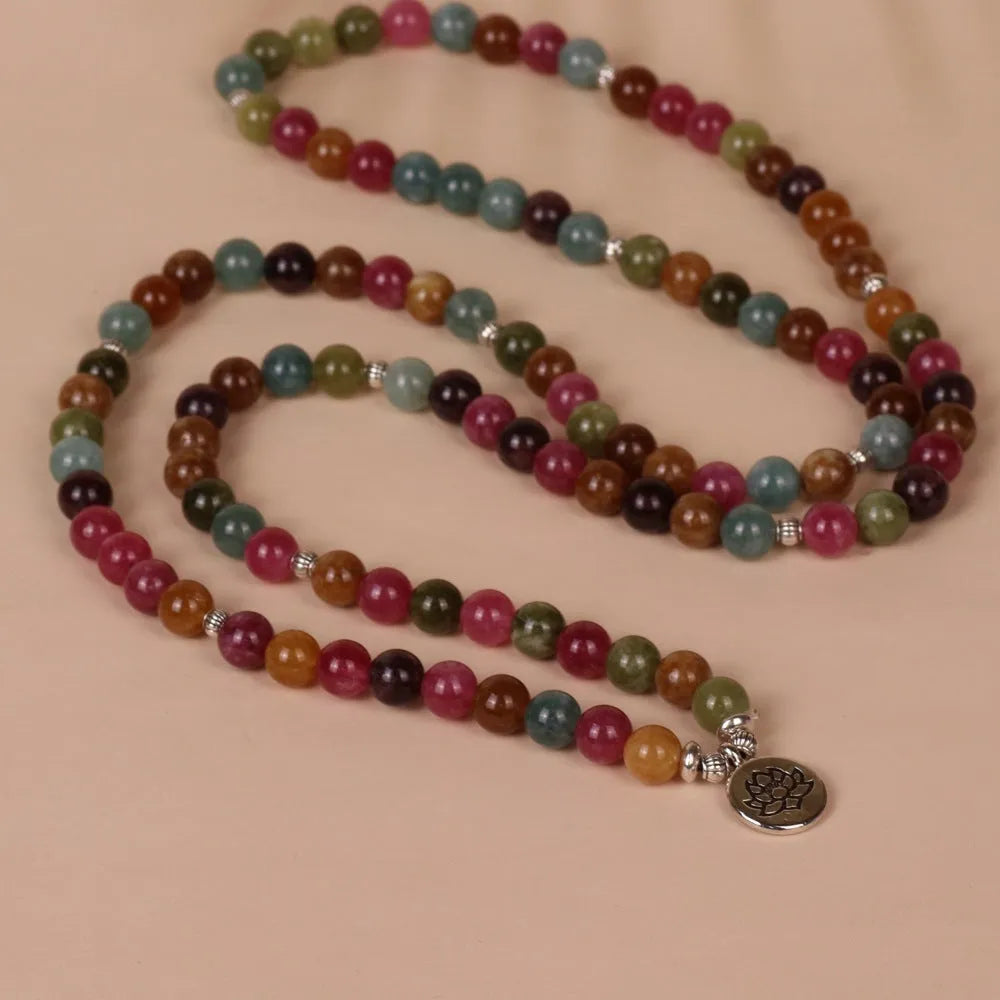 Tourmaline-colour alloy bracelet with 108 beads in a lotus string design laid flat