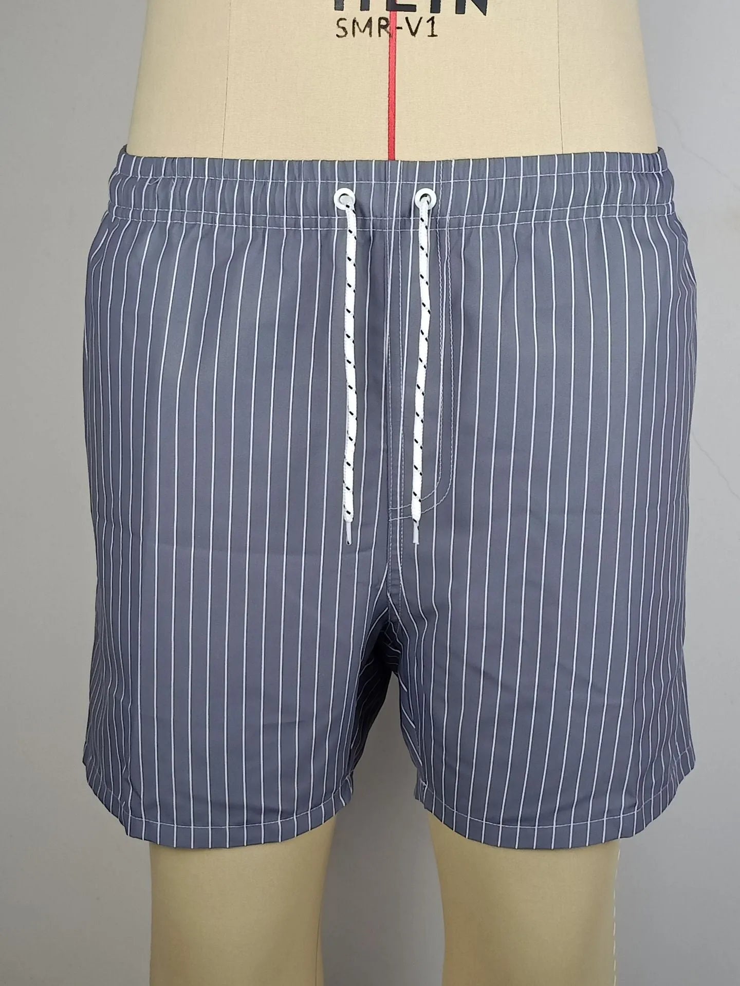 Men's striped beach shorts in light blue with a straight leg and triangle lining.