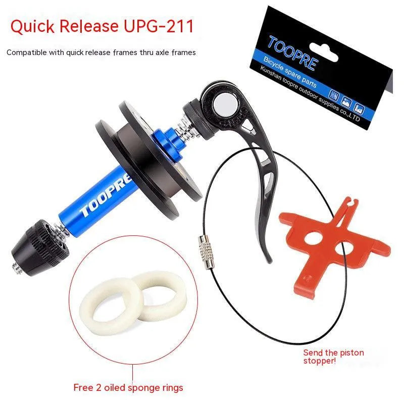 Aluminium bicycle chain holder tool for washing and tension measurement on a workbench.