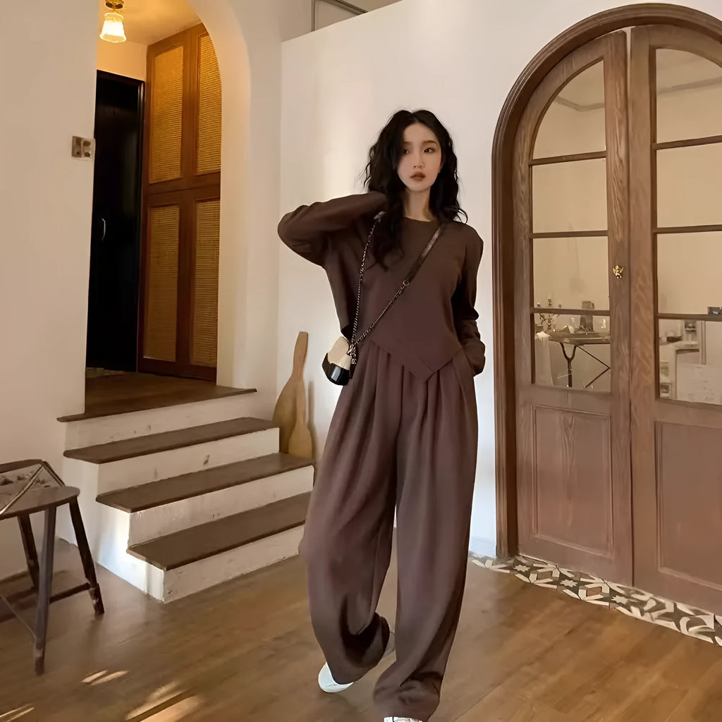 Women's loose khaki casual sports suit set with long sleeves and trousers on a hanger.