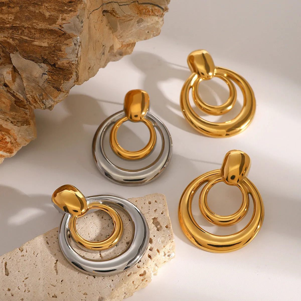 Gold-plated titanium steel hollow stud earrings with double-layer round geometry design