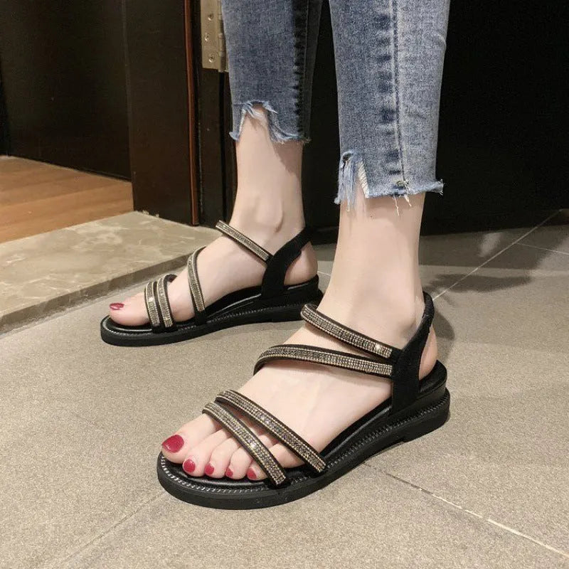 Women's silver flat sandals with rhinestone decoration and elastic band on a rubber sole