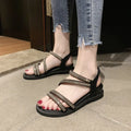 Women's silver flat sandals with rhinestone decoration and elastic band on a rubber sole