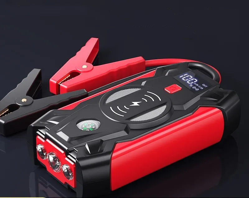 Red portable car battery jump starter power bank with digital display and jumper cables
