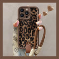 Brown leopard print silicone lanyard phone case for iPhone on a table