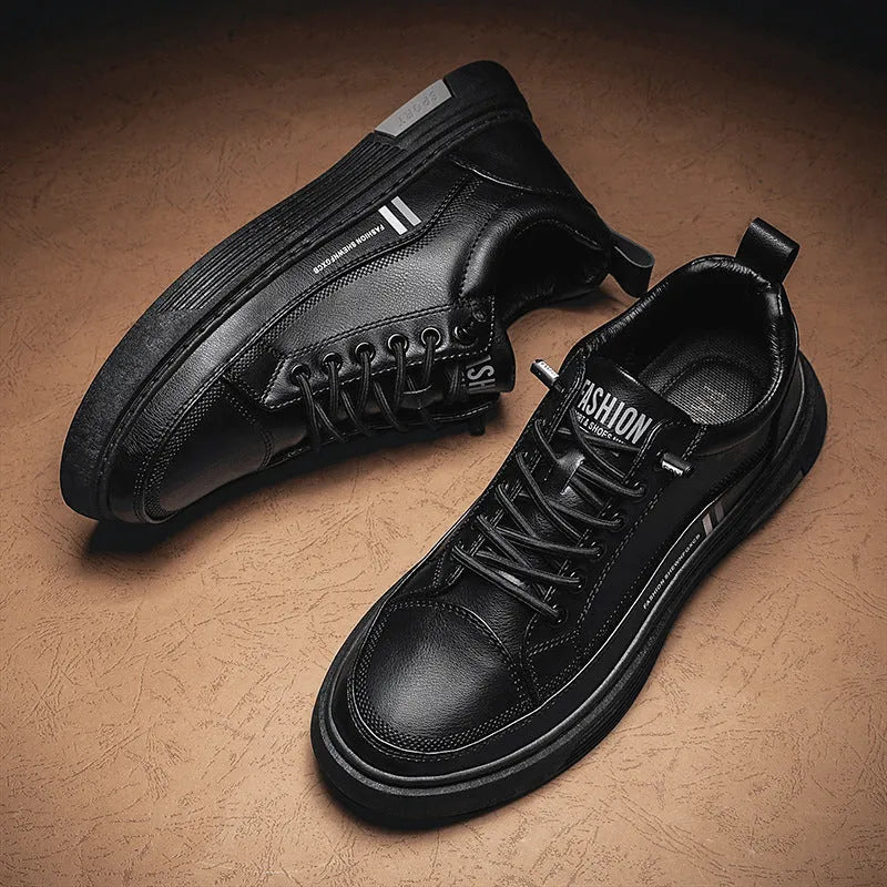 Men's low-top skate shoes in black with a round toe, elastic band, and rubber sole.