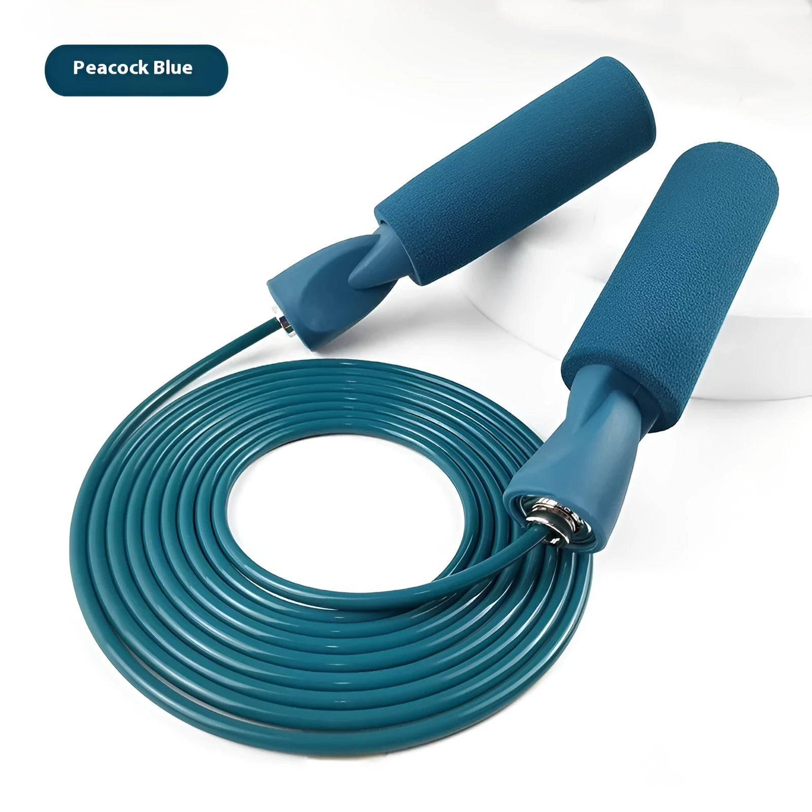 PVC bearing wire rope fitness skipping rope in peacock blue with handles on a plain background