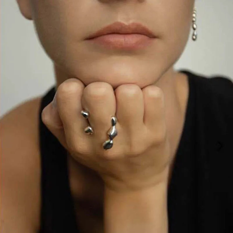 Gold and silver adjustable opening fashion ring with spherical design on a brass base.