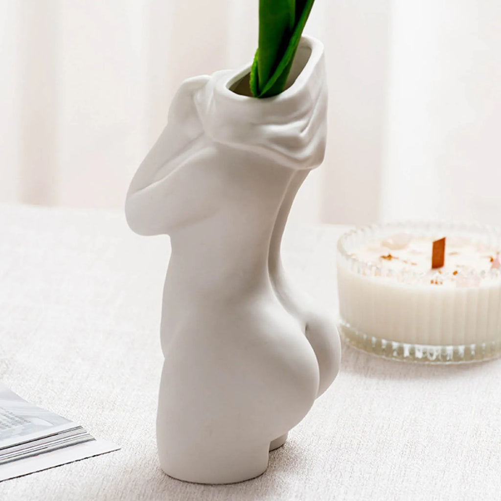 White porcelain figurative human vase with 21.2cm height on a shelf