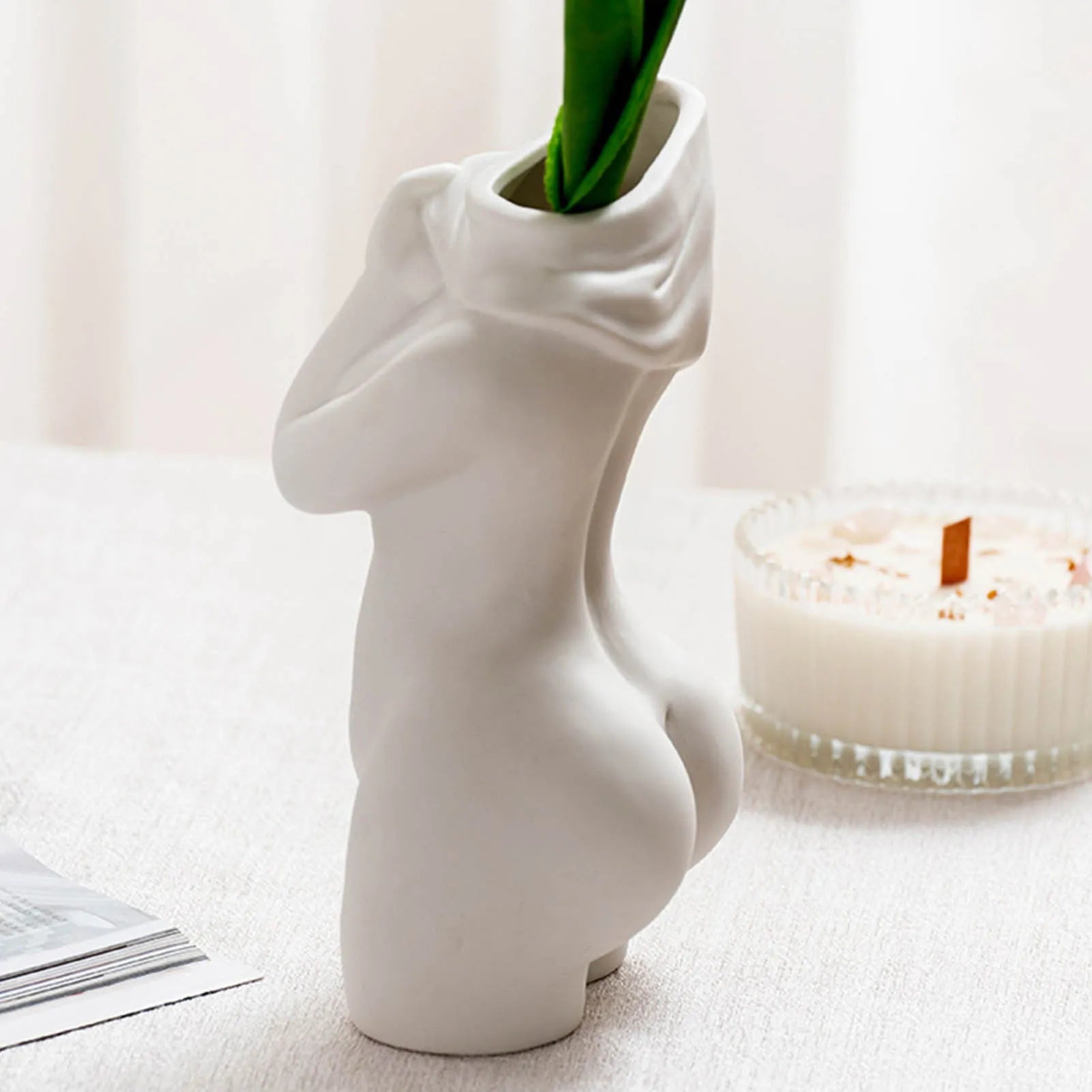 White porcelain figurative human vase with 21.2cm height on a shelf