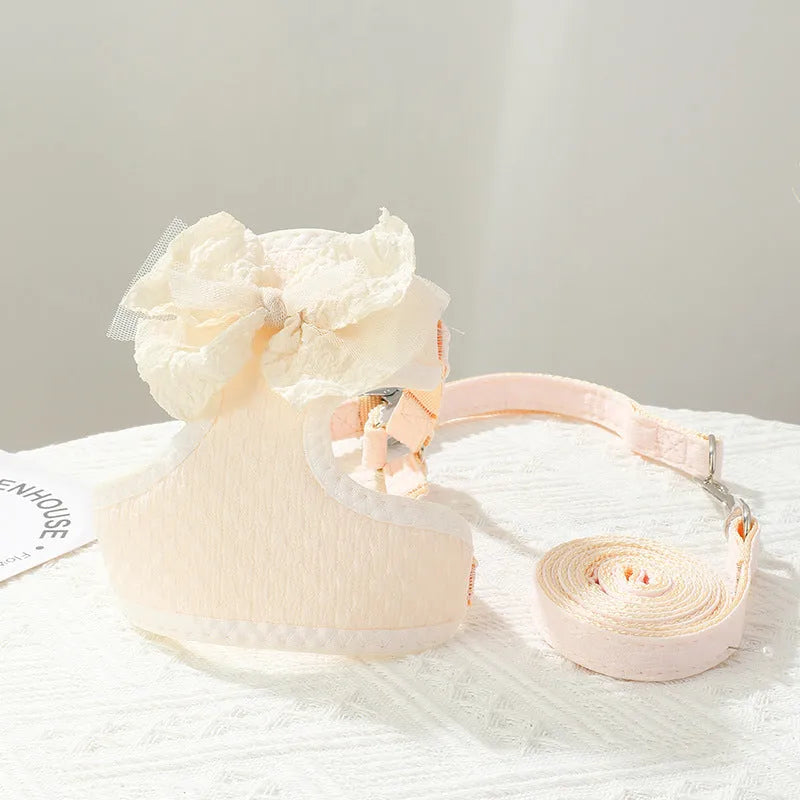 Hand holding rope chest strap for small puppies in beige cloth on a light background