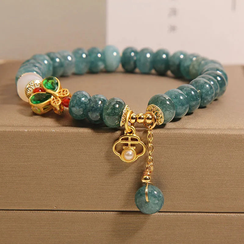 Women's blue water jade and white agate abacus bead bracelet with rhinestones and a butterfly charm on an alloy chain.