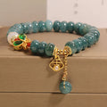Women's blue water jade and white agate abacus bead bracelet with rhinestones and a butterfly charm on an alloy chain.