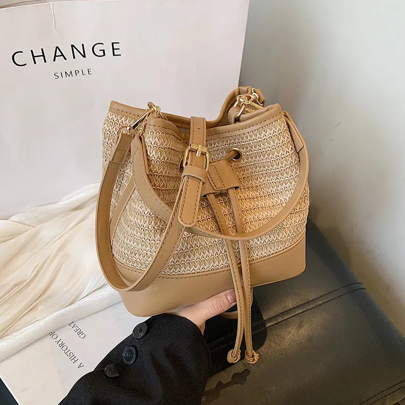 Woven straw women's crossbody bucket bag in horizontal square shape with adjustable shoulder strap