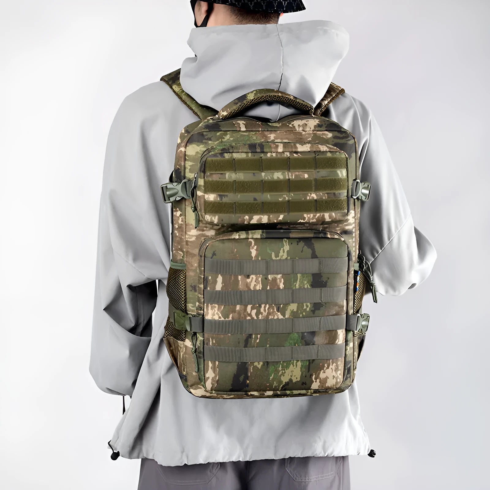 Outdoor mountaineering backpack in camouflage colour with curved shoulder straps and multiple compartments