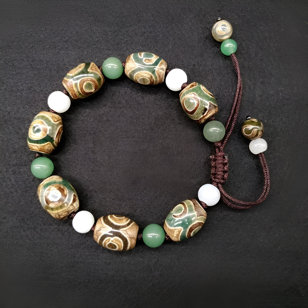 Green agate ethnic bracelet with hand-woven beads showing geometric patterns and three-eye design details