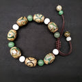 Green agate ethnic bracelet with hand-woven beads showing geometric patterns and three-eye design details