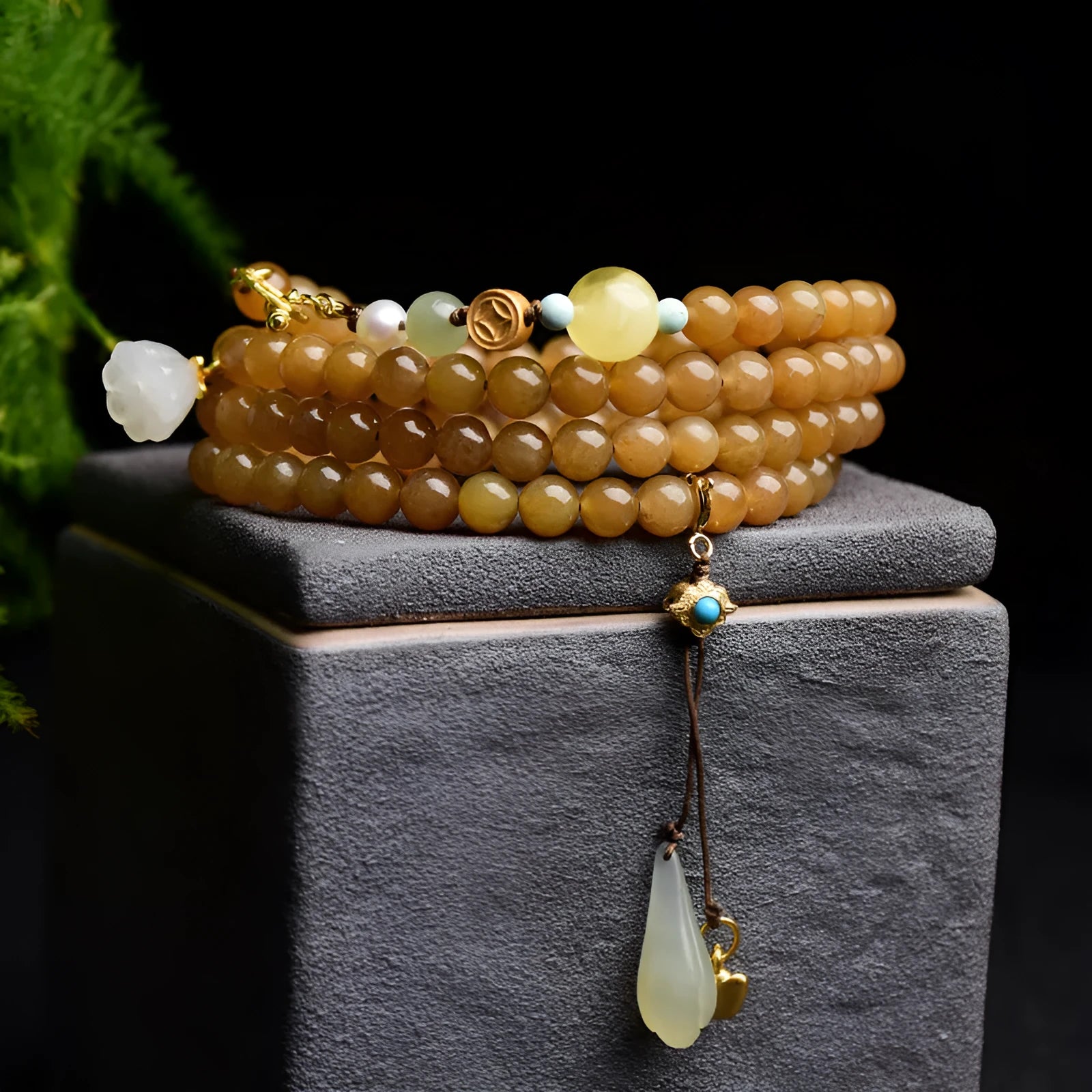 Women's jade bracelet with 6mm round beads in clear water green featuring leaf accents
