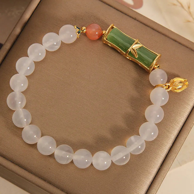 Women's white agate and jade beaded bracelet with bamboo joint connector in retro Chinese style.