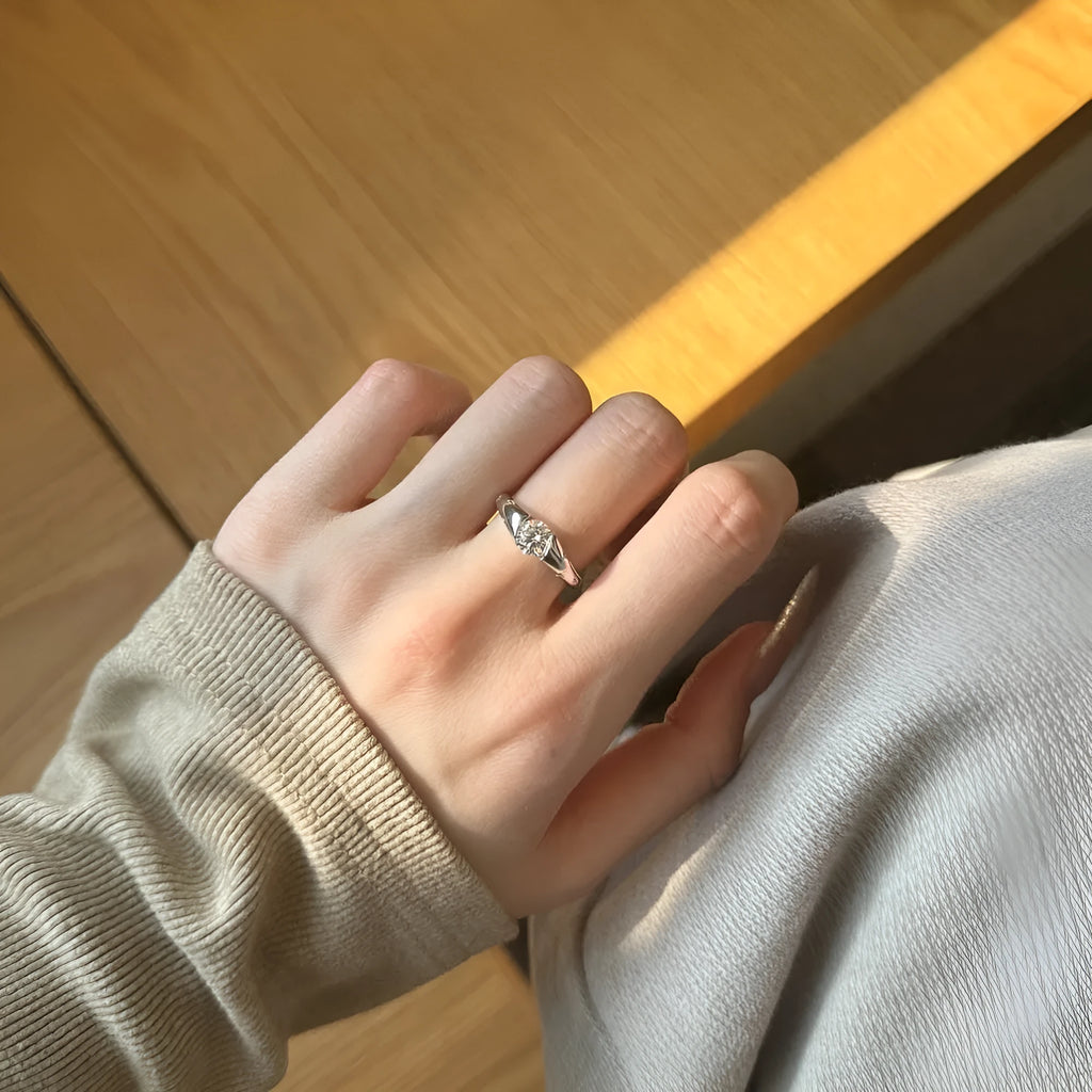 Silver round ring with glossy electroplated finish on display