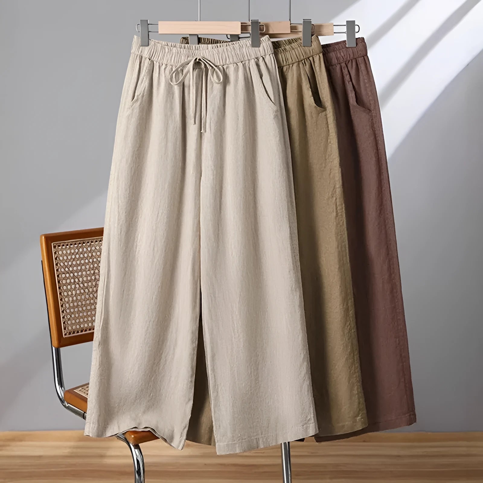 Women's straight-leg casual trousers in apricot colour with an elastic waistband and lace-up drawstring detail.