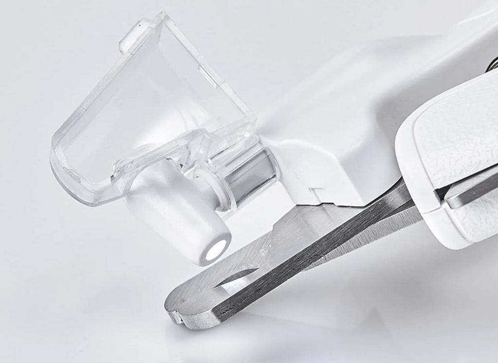 White pet nail clippers with LED light, transparent guard, and built-in file for cats and dogs.