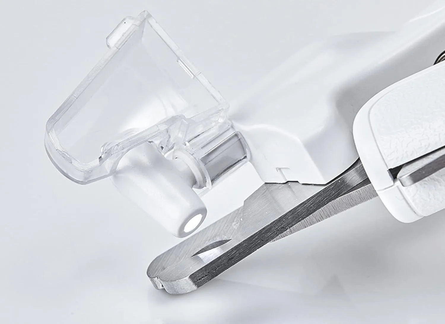 White pet nail clippers with LED light, transparent guard, and built-in file for cats and dogs.