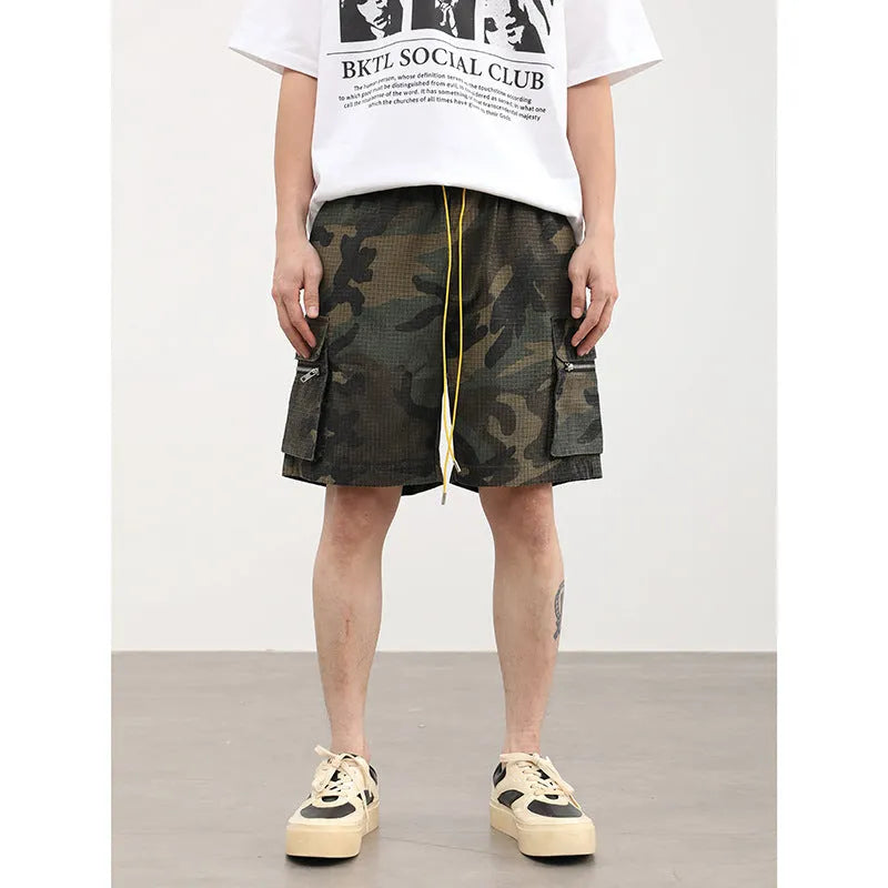 Men's camouflage cargo shorts showing multiple pockets and cropped leg length