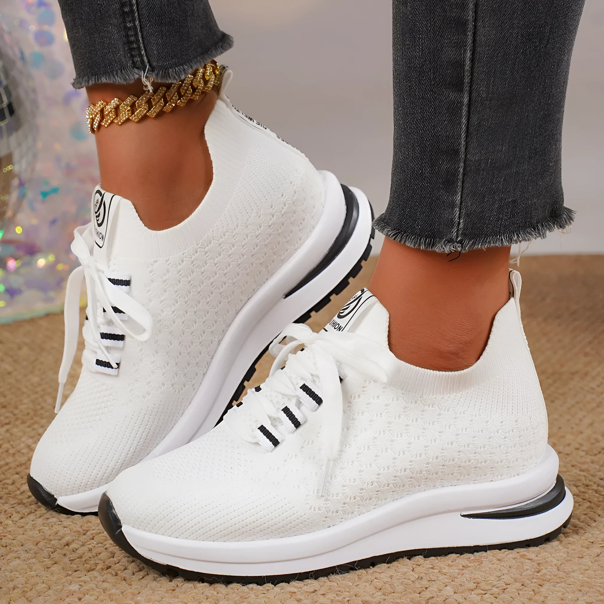 Women's black mesh lace-up flat platform sneaker on a white background