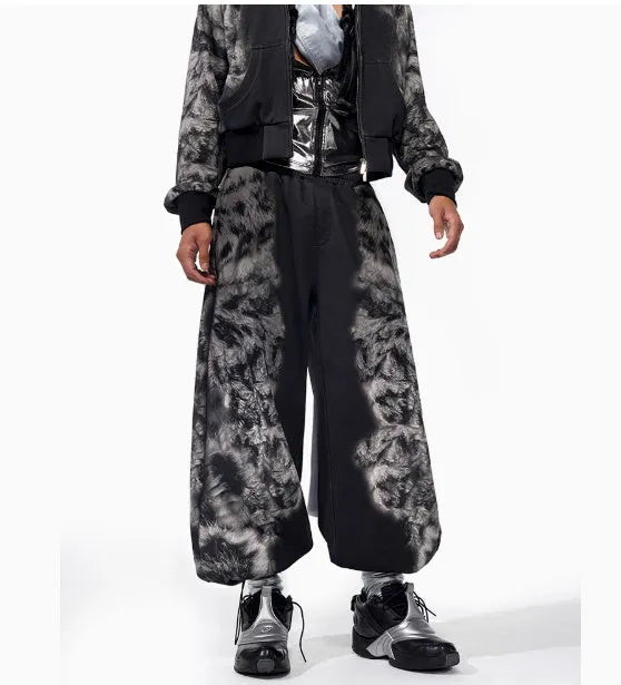 Loose fitting printed casual trousers with a hoodie on a neutral background