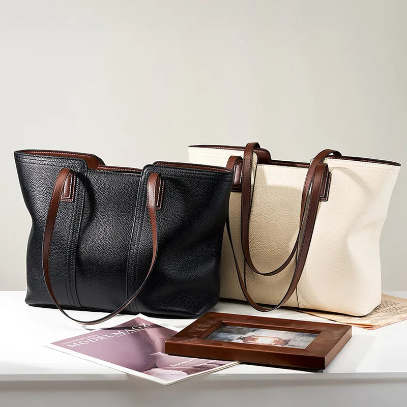 Women's black genuine leather crossbody bag with square shape and single shoulder strap.
