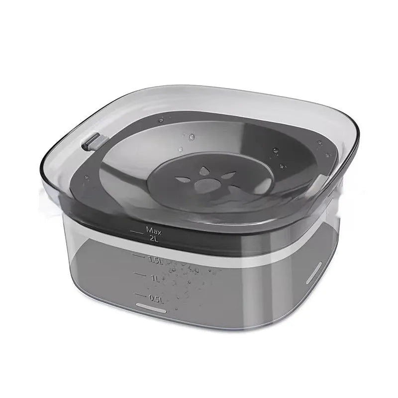 Transparent large 2-litre dog water bowl with floating slow drink disc on a non-slip base.
