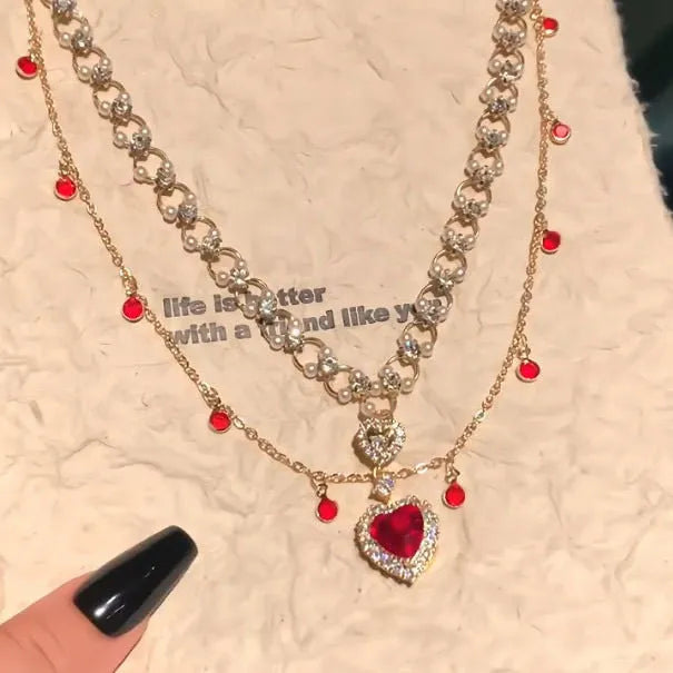 Red love heart and pearl charm on a double-layer adjustable alloy necklace.