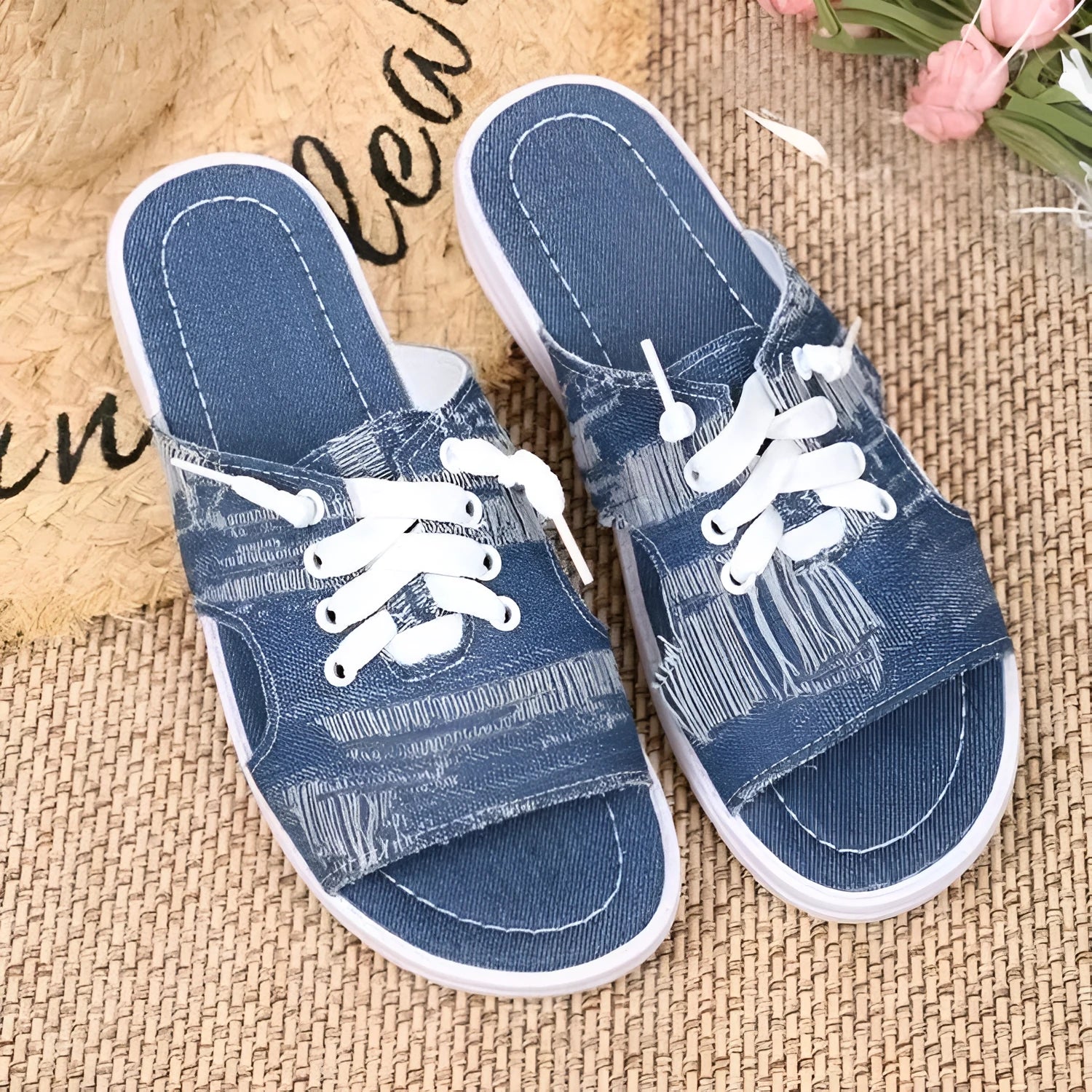 Blue women's flat canvas slippers with cloth lining and a rubber sole, shown in Roman style.