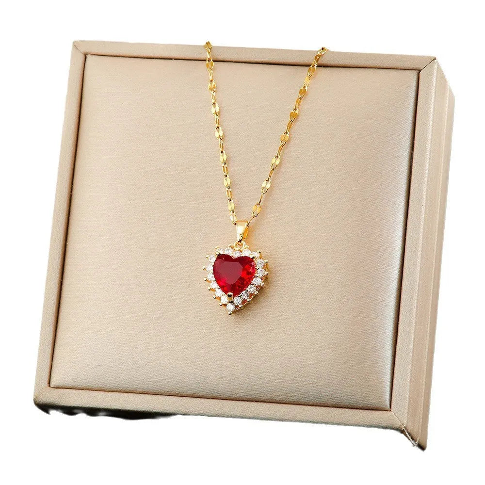 Gold red heart and flower pendant necklace, ear studs, and ring set made from titanium steel with gemstone inlays.