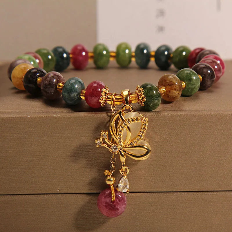 Colourful women's bracelet with a silver butterfly charm and multicoloured beads including tourmaline