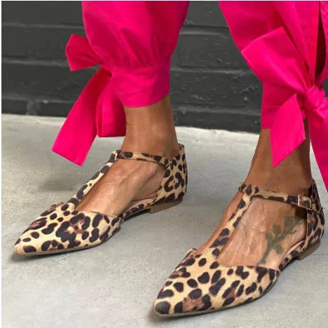 Women's leopard print pointed toe pumps with a short chunky heel and ankle strap.