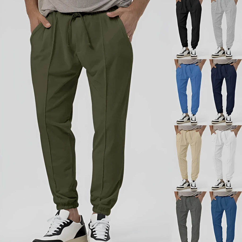 Men's grey cotton blend casual track sweatpants with a tapered leg on a plain background.