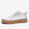 Men's black leather casual shoes with round toe and white flat rubber sole on a plain background