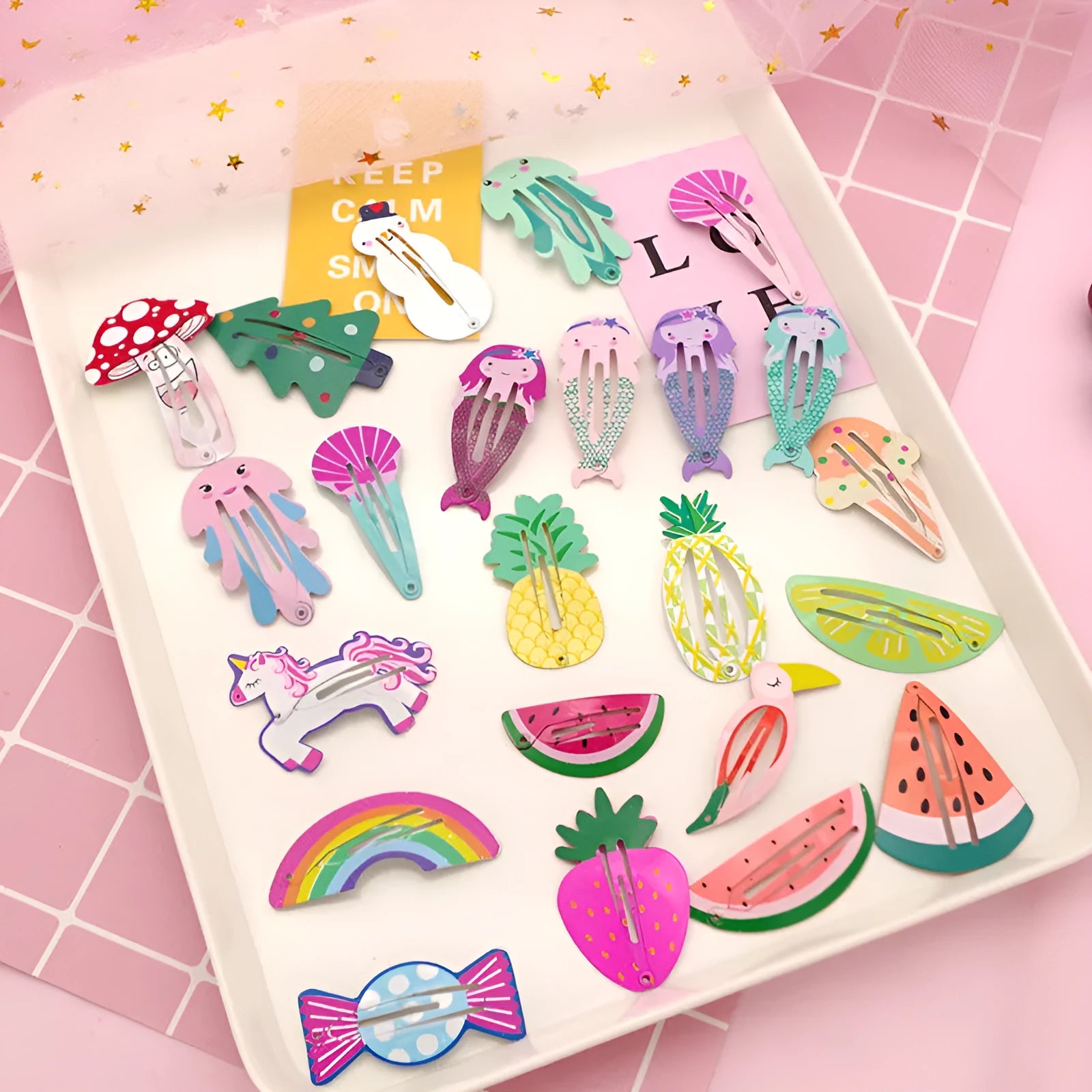 Metal children's hair barrette with baked varnish print, showing examples of watermelon, strawberry, and pineapple designs.