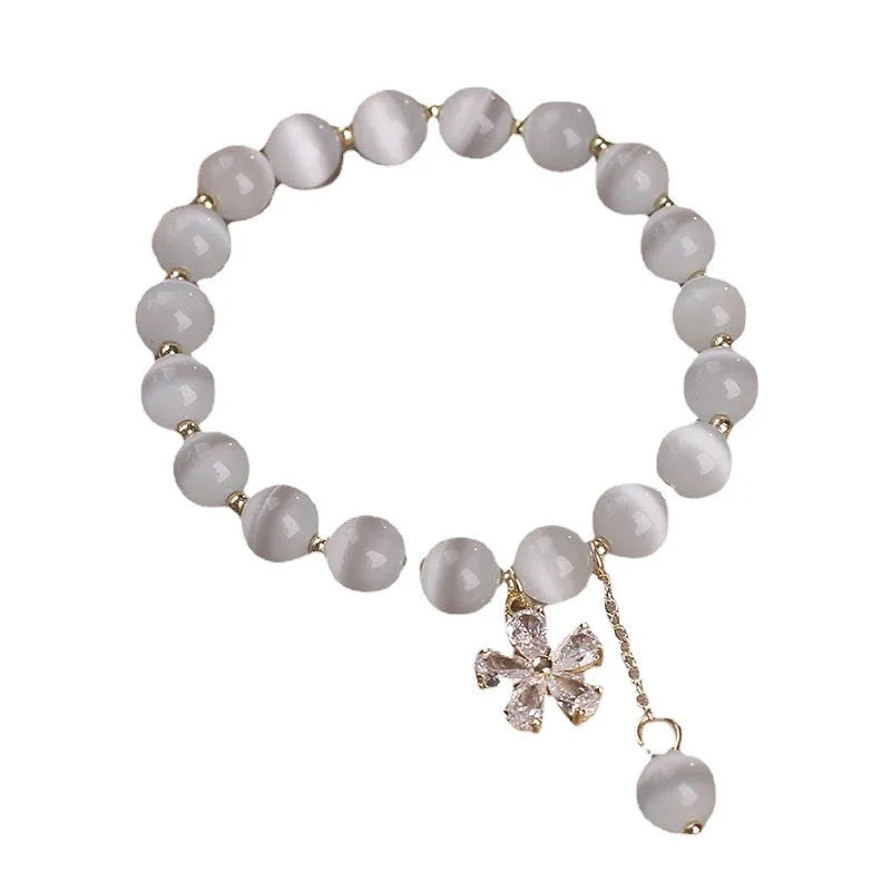 Women's white cat's eye stone bracelet with morganite pendant and flower tassel on safety buckle clasp