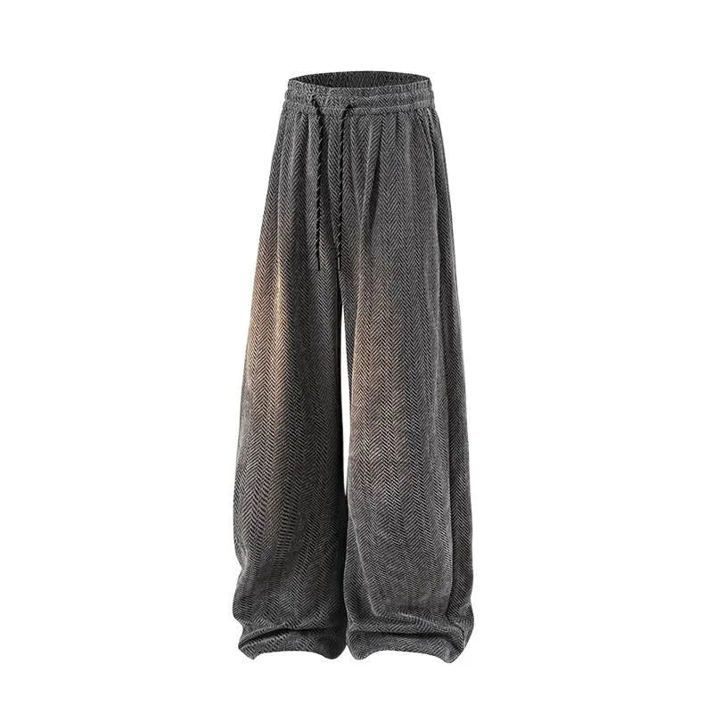 Plus size black straight-leg trousers with hollow-out design and elastic waistband laid flat.