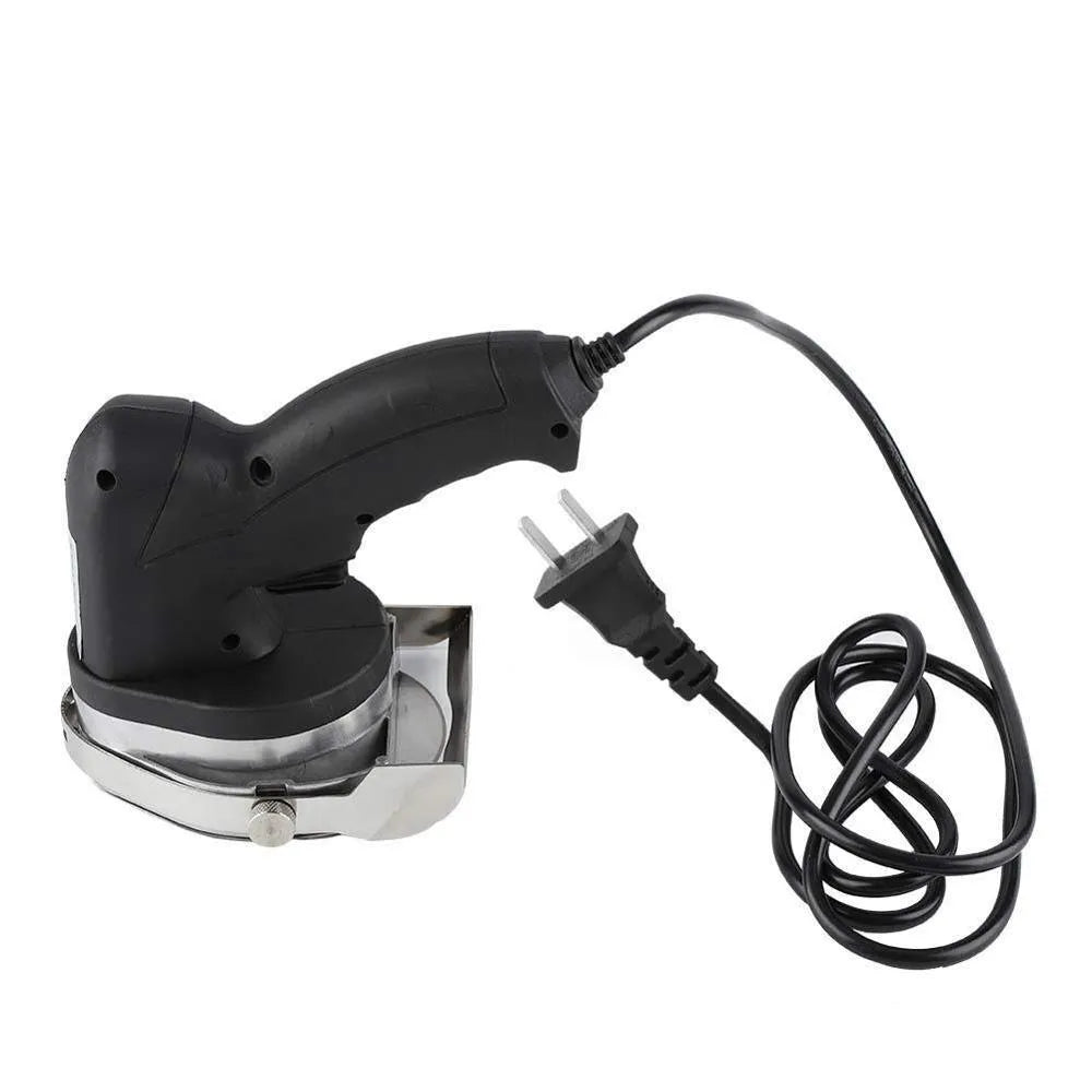 Black electric meat cleaver with power cord for turkey barbecue machines on a kitchen counter