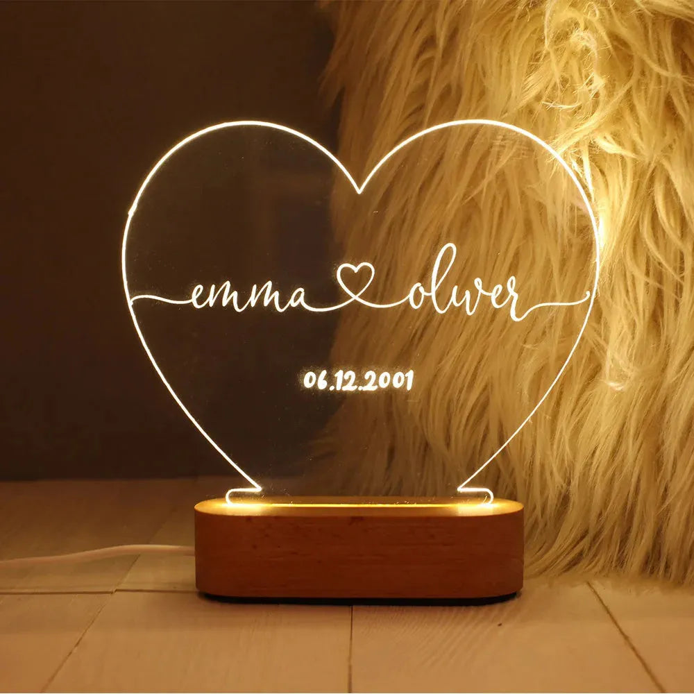 Custom transparent acrylic LED night light etched with personal names and date.