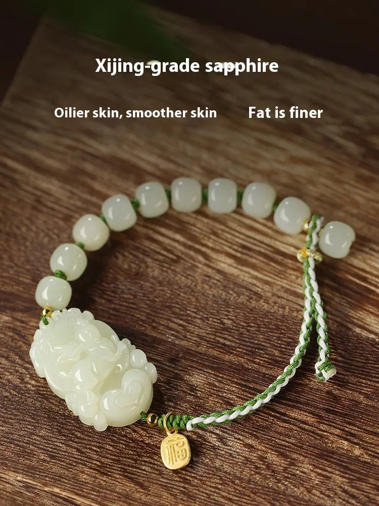 Year of the Rabbit Hetian jade charm bracelet with S925 silver detailing on a red cotton rope.