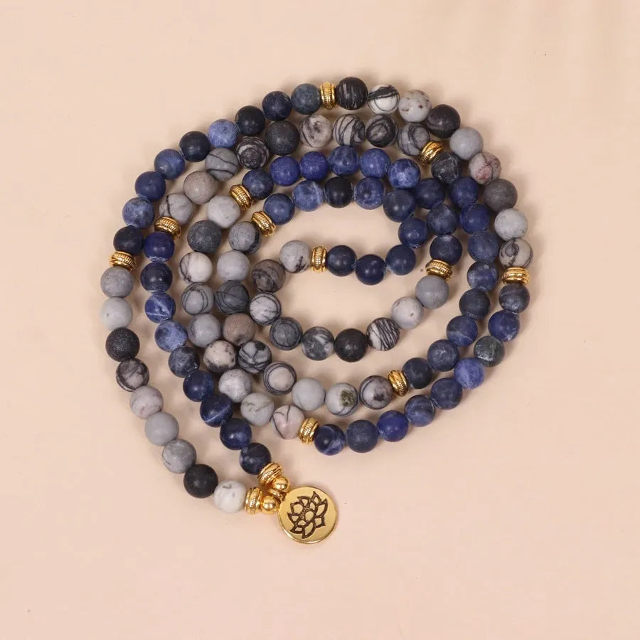Blue multi layer bracelet with patterned network stone beads on alloy strands