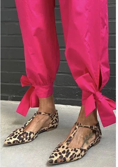 Women's leopard print pointed toe pumps with a short chunky heel and ankle strap.