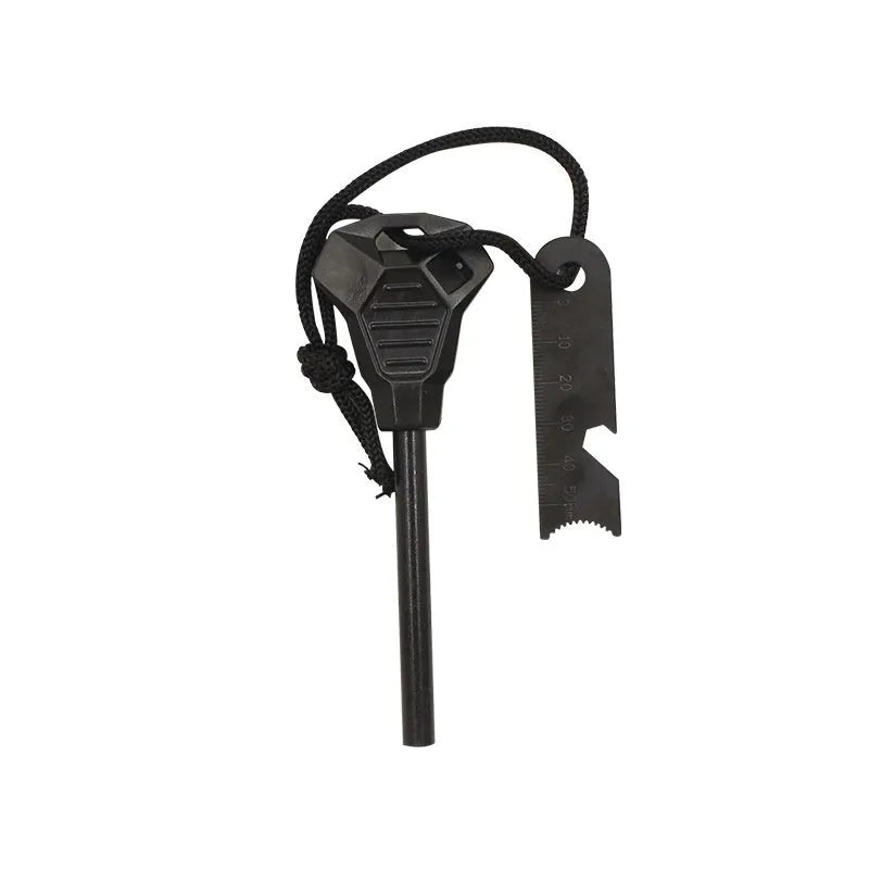 Black outdoor multifunctional survival flint tool with stainless steel scraper on a dark background.